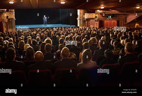Audience Watching Performer On Stage In Theater Stock Photo Alamy
