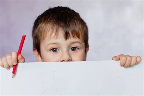 Funny Child Boy Looks For A Drawing Album Little Boy Is Holding Color