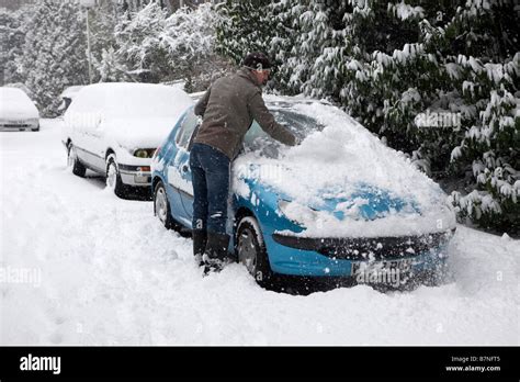 A Man Cleans Snow From His Car In Muswell Hill North London On The 2nd