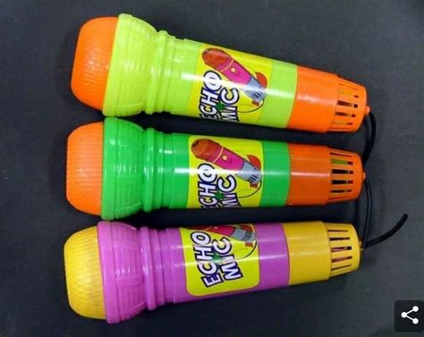 Three Orange Green And Pink Crayons Sitting On Top Of A Black Table