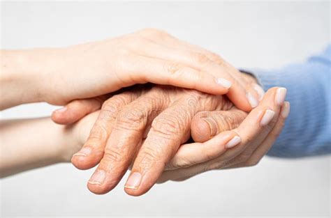 Young Hands Hold Old Hands Support For The Elderly Concept Stock Image