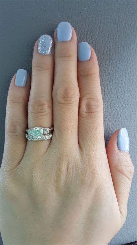 Silver or metallic gray is a color tone resembling gray that is a representation of the color of polished silver. Light blue nails with clear silver glitter accent nail ...