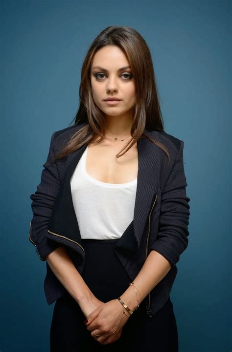 Mila Kunis Wearing A Suit And Showing Some Cleavage