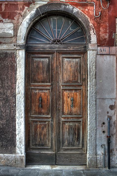 Find secure, sturdy and trendy front door big at alibaba.com for residential and commercial uses. an old wooden door in Italy Photograph by Joana Kruse