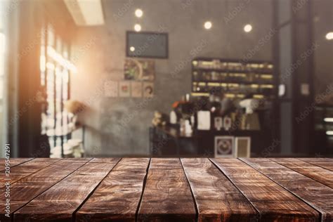 Empty Old Wood Table Top And Blurred Bokeh Cafe And Coffee Shop