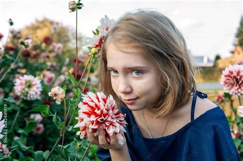 13 Year Old Girl With A Dahlia Flower Portrait Of A Girl Admiring A