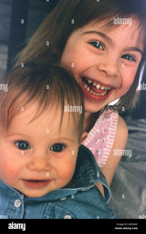 Two Sisters Girls Pose With Each Other Stock Photo Alamy