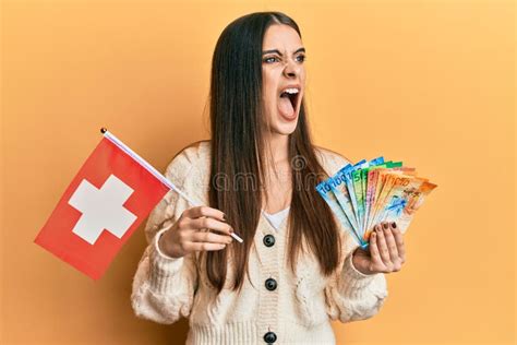 Beautiful Brunette Young Woman Holding Switzerland Flag And Franc