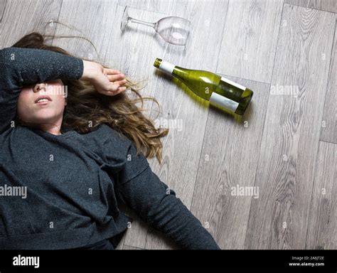 Drunk Alcoholic Young Girl Lying On The Floor Feeling Sick By Drinking