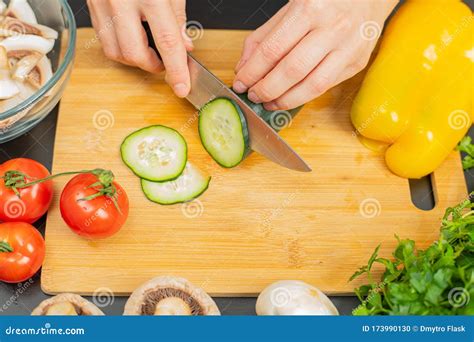 Woman Is Cutting Cucumber On Cut Board On Kitchen Stock Photo Image