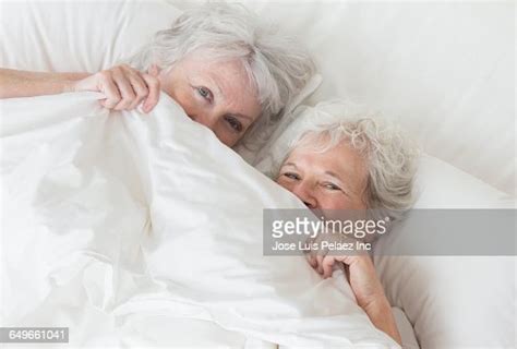 Older Caucasian Lesbian Couple Laying In Bed Photo Getty Images