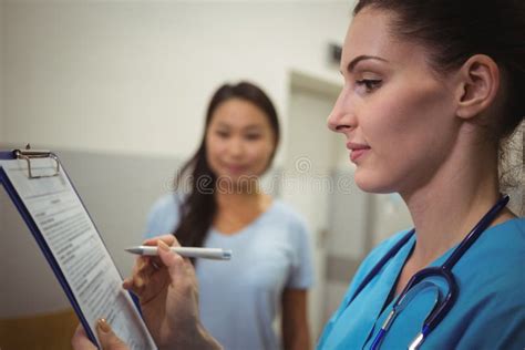 Female Nurse Writing On Clipboard Stock Image Image Of Clinical