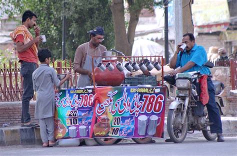 People Drinking Traditional Summer Drink Lassi Displayed By Roadside Vendor To Attract The