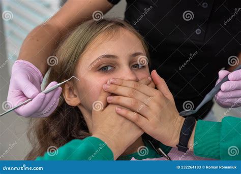 Girl At The Dentist`s Office Closes Her Mouth With Her Hands Stock