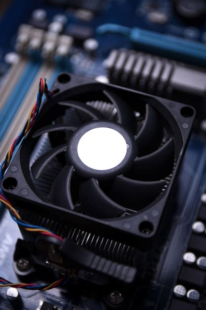 Premium Photo Computer Fan On Motherboard And Electronical Components
