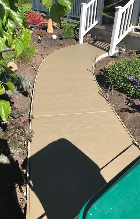 The iron railing is going to be secured with metal brackets that the posts will be locked into. Photo Gallery - Precast Concrete Steps and Iron/Vinyl Railing