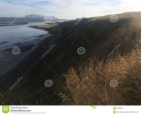 Landscape With Cliff And Mountain Range At The Ocean Light Reflections