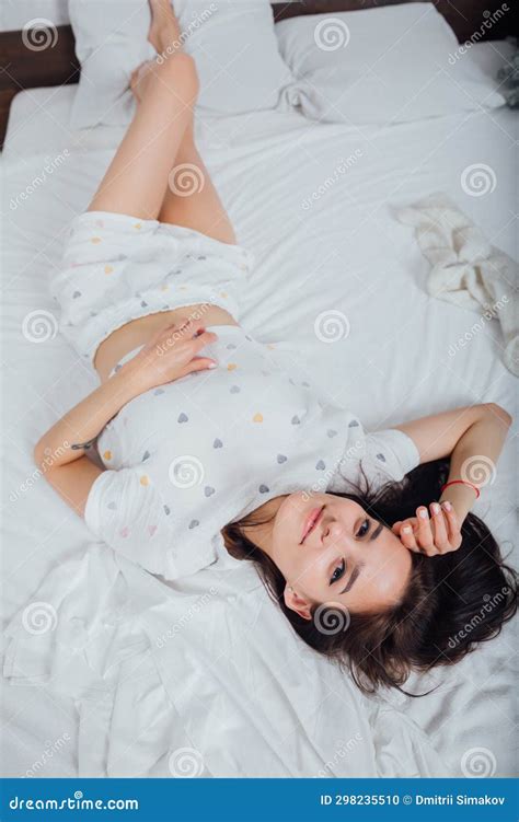 Beautiful Woman In Pajamas Sleeping In Bedroom On Bed Stock Photo