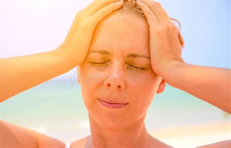 headache woman on sunny beach woman with sunstroke hot sun danger health problem on holiday