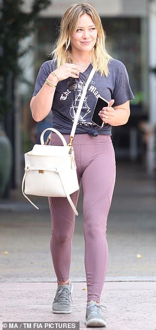 hilary duff smiles while shopping at upscale boutique in knotted t shirt and leggings in los