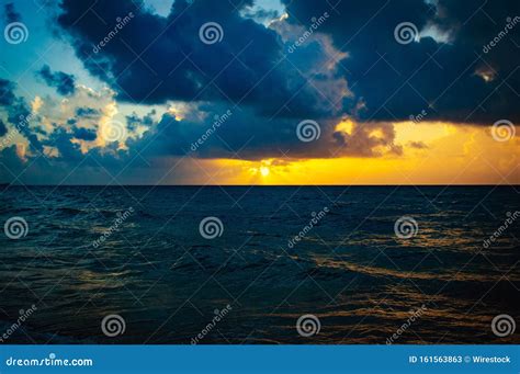 Breathtaking Sunset Over The Navy Blue Ocean Creating A Dangerous