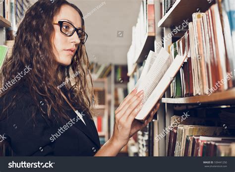 Woman Wearing Glasses Reading Book At Library Stock Photo 109441250