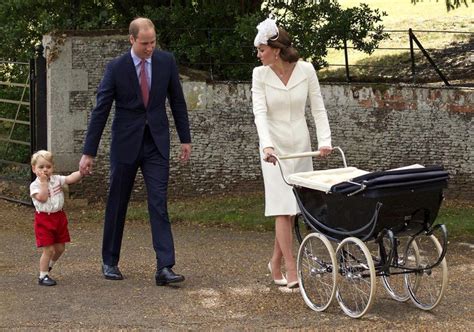 The Prince And Princess Are Walking With Their Baby In A Stroller While