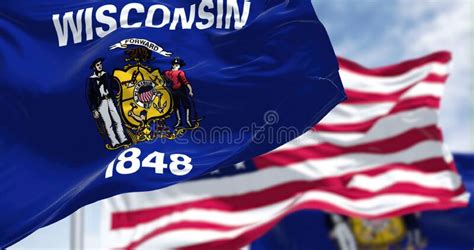 The Wisconsin State Flag Waving Along With The National Flag Of The Us
