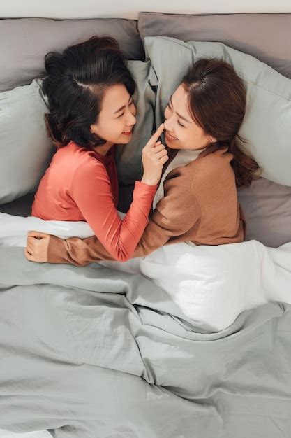 Premium Photo Young Lesbian Women In Love Embracing While Lying Don
