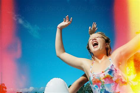 Girl Jumping In Swim Suit In Front Of Blue Sky With Light Leak On Film