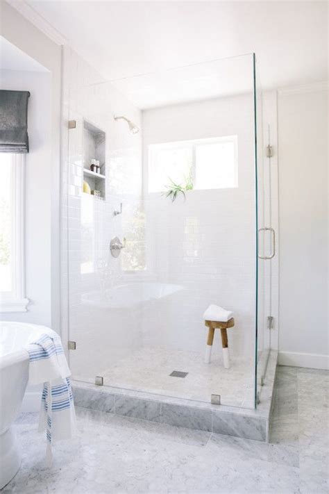 Master Bathroom Features A Corner Seamless Glass Shower Filled With White Subway Tiles Framing