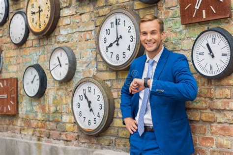 Man In Suit Standing Near Wall With Clocks Stock Photo Image Of