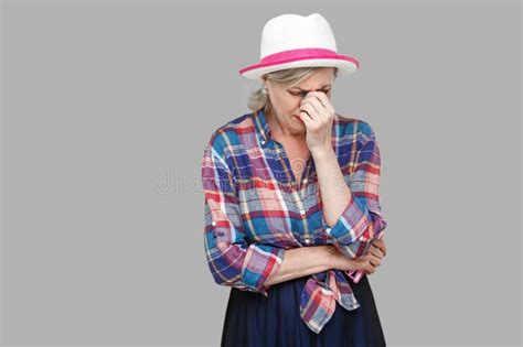 Portrait Of Sad Alone Depressed Mature Woman In Casual Style With Hat
