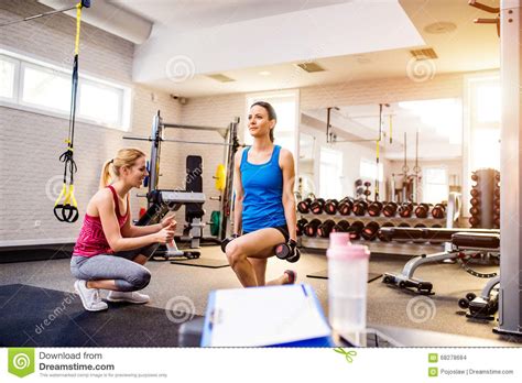 Gym Women Exercising With Personal Trainer Clipboard Water Bo Stock