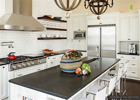 By bringing the backsplash from the countertops to the ceiling, the designer created a sizable accent wall that appears as if it was carved right out of the earth. Black Countertop Backsplash Ideas - Backsplash.com | Kitchen Backsplash Products & Ideas