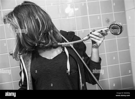 Sad European Teenage Girl In Shower Bath Depression Mood Concept Black And White Photo Stock