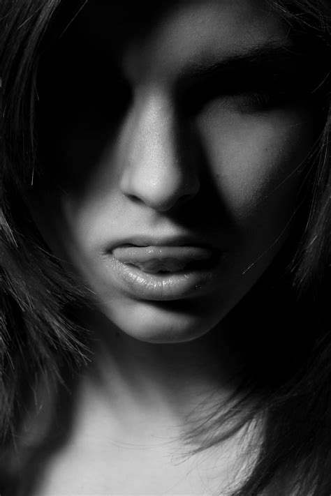 Grayscale Photography Of Woman Sticking Her Tongue Out