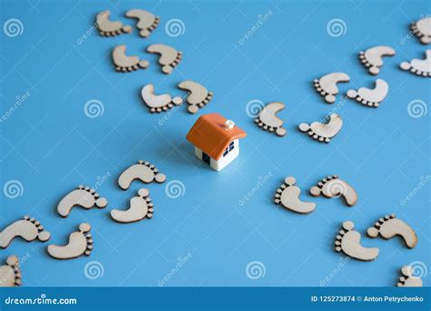 The Concept Of Returning Home Footprints Lead To The House Stock Photo