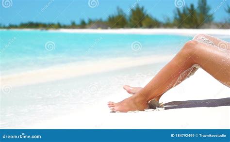 Female Slim Tanned Legs On A White Tropical Beach Slow Video Stock