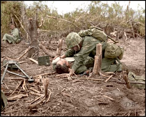 A Wounded Us Marine Is Given A Drink Of Water From The Canteen Of A
