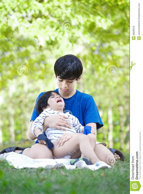 Older Brother Comforting Little Boy Stock Photo Image Of