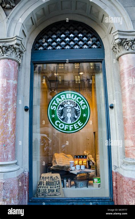 The Window Of A Starbucks Coffee Shop Featuring The Iconic Starbucks