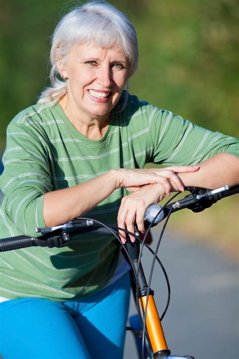 Mature Woman With Bicycle Stock Image Image Of Activity