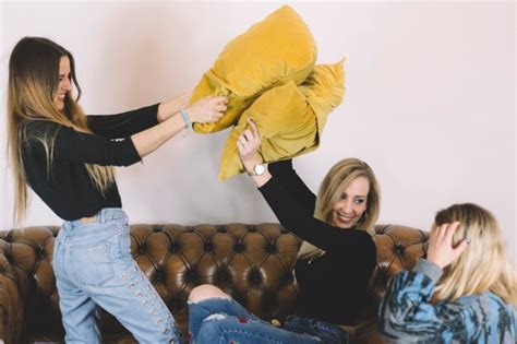 Free Photo Women Having Pillow Fight On Sofa