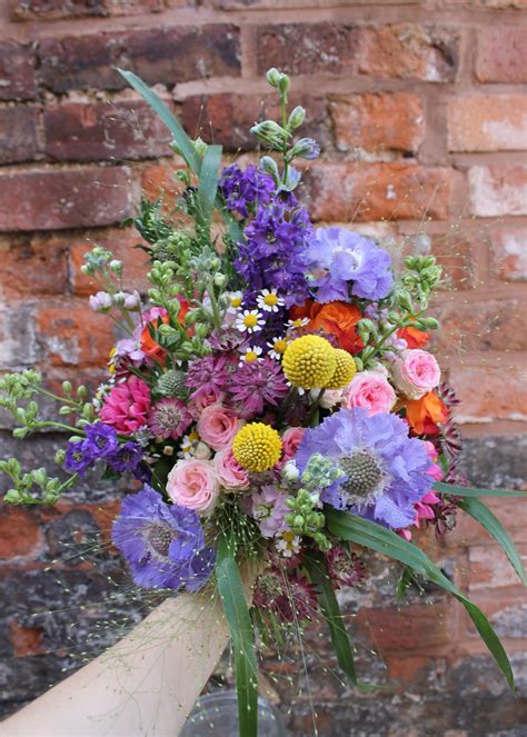 wild and wonderful bridal bouquet of mixed garden style flowers an array of summery colours