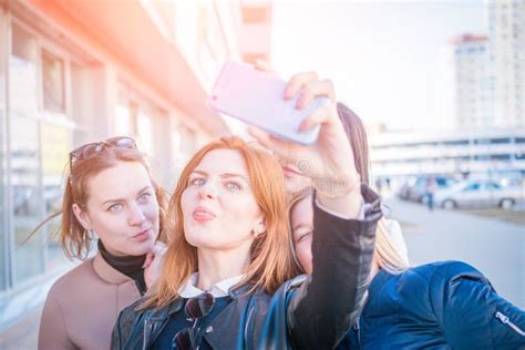 Four Young Very Attractive Women Take Selfies On Urban Streets Stock