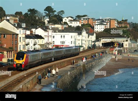 Virgin Passenger Train Passing Through The Devonshire Seaside Resort Of
