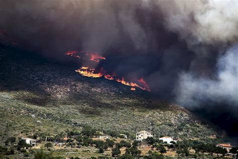 greece fire rages on the hills around athens causing residents to flee