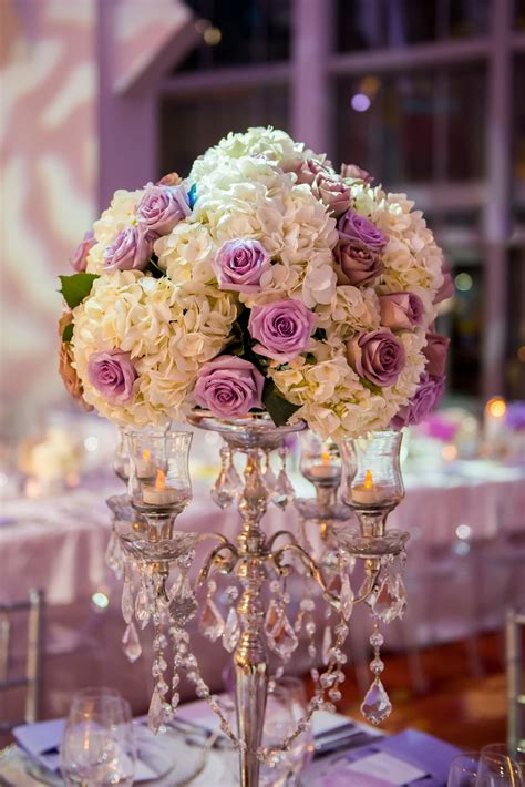 The gorgeous white and purple bridal bouquet contained a variety of blooms—from peonies to hydrangeas and lavender. Lavender Rose and White Hydrangea Candelabra