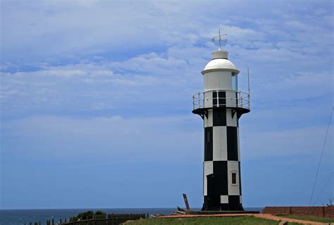 Free Images Sea Coast Lighthouse Sky White Black Clouds